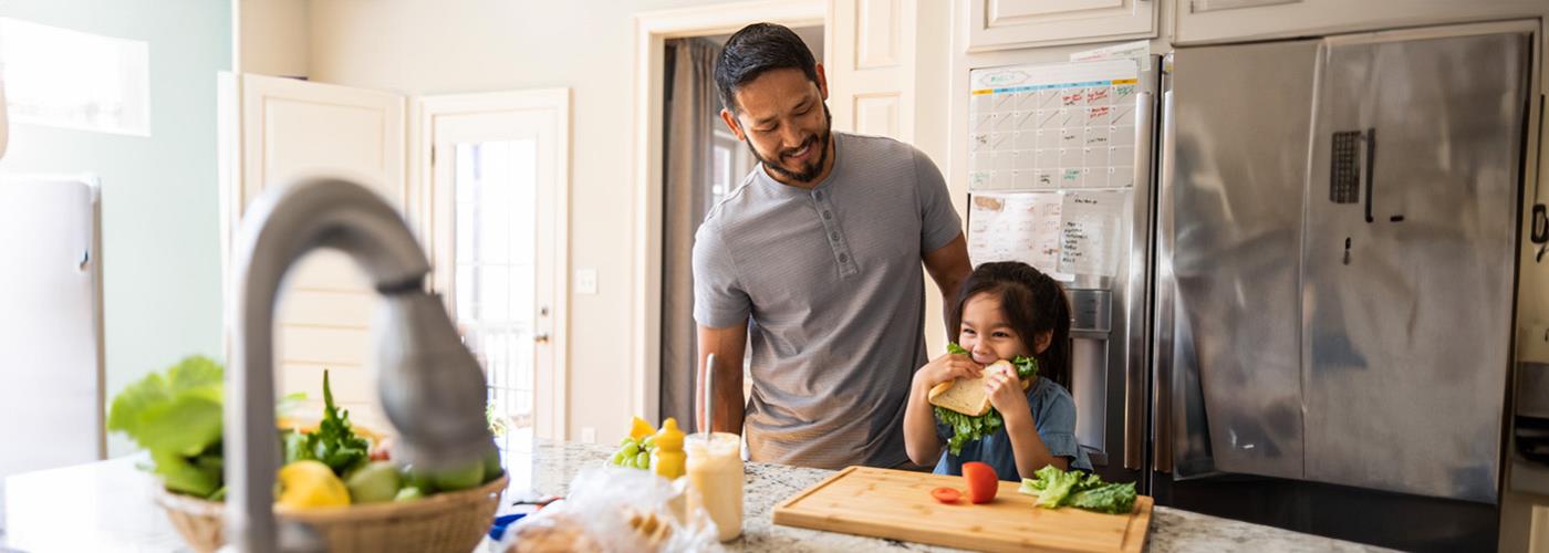 father watching kid eat