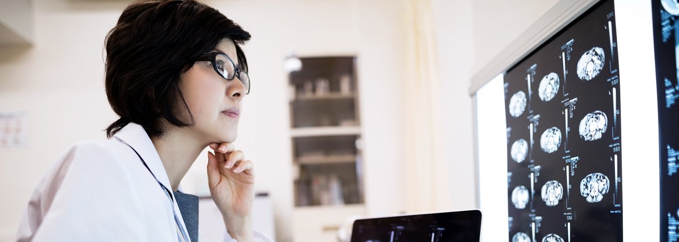 Neurologist in Penang reviewing brain scan results at Pantai Hospital